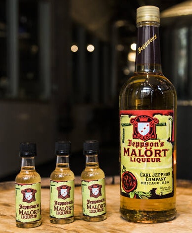 Photo of three 50 milliliter bottles of Jeppson's Malort and one 750 milliliter bottle of Jeppson's Malort