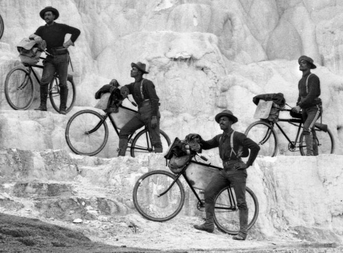 Photograph of Riders of the 25th Infantry, U.S. Army Bicycle Corps stopped at Minerva Terrace in Yellowstone National Park, Wyoming.  October 7, 1896