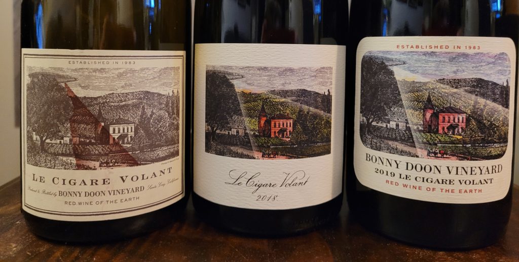 Photo of three vintages of Le Cigar Volant red blend wine from Bonny Doon Vineyards: 2012, 2018, 2019
