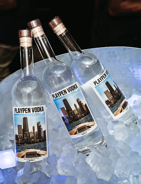 Image of three 750ml bottles of PlayPen Vodka chilling in a tub of ice. 